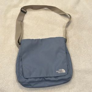 The North Face light blue crossbody bag.. gently used, lots of pockets.